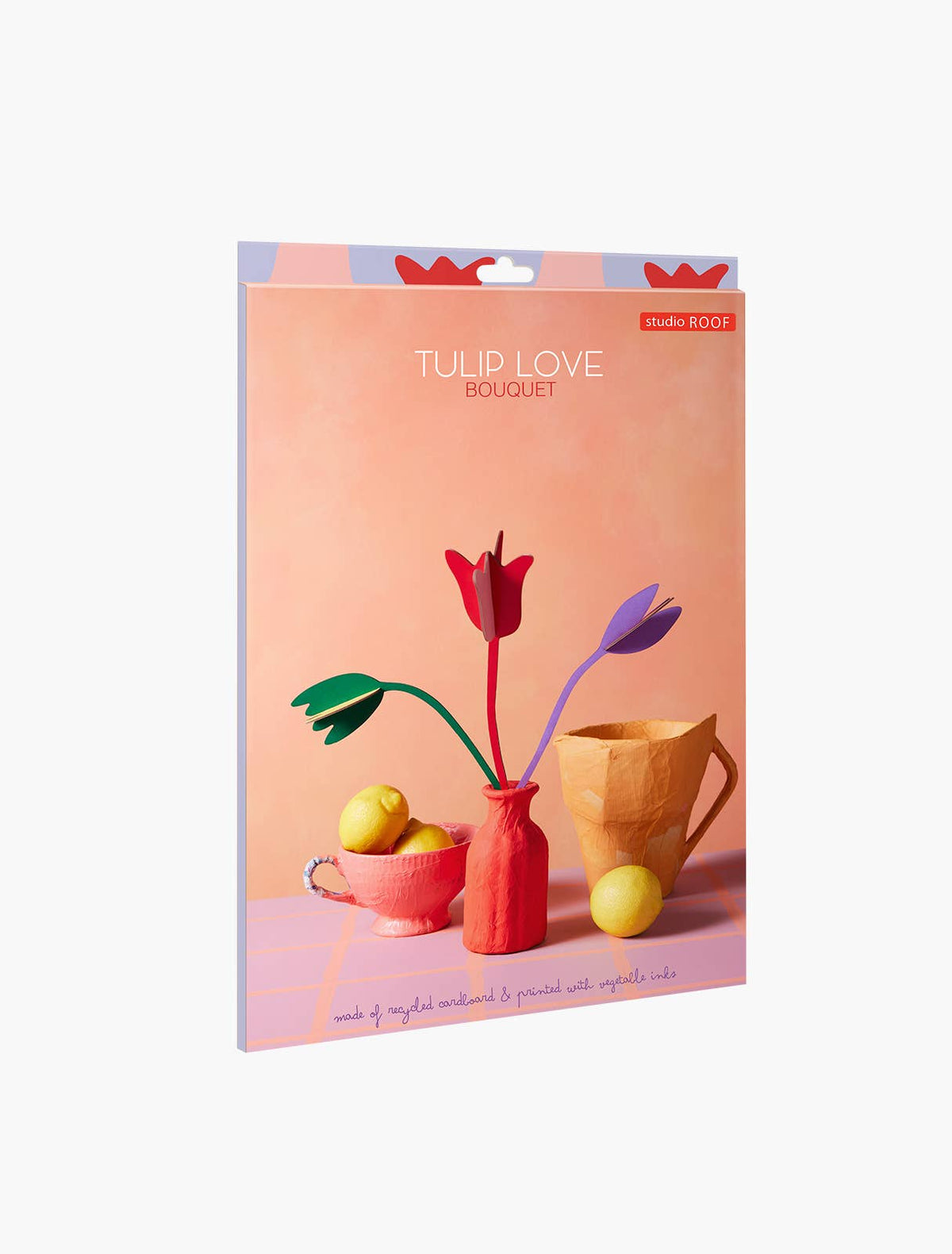 Studio ROOF Tulip Love Bouquet package showing red, purple and green cardboard tulips in a coral vase beside lemons